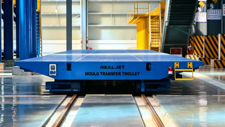 Rail-mounted mould transfer trolley used to move production equipment between precast beam workstations