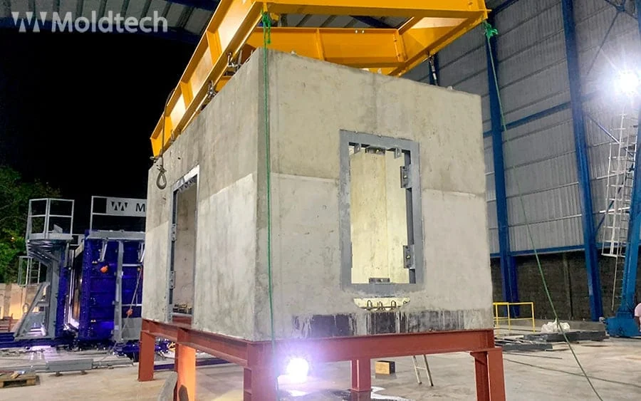 Heavy concrete box module lifted by a gantry crane