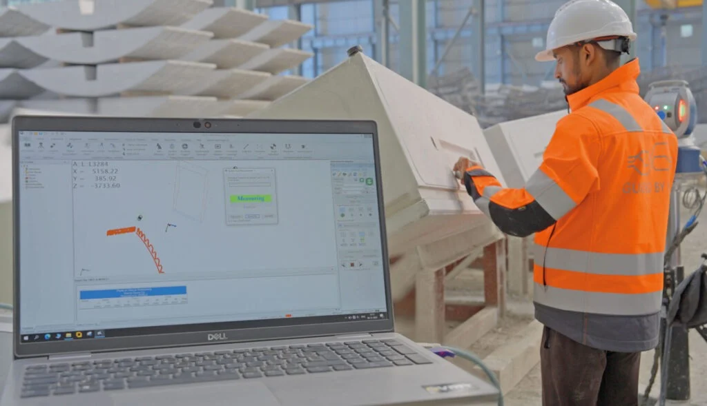 Technician using a laser tracker to inspect a precast concrete segment