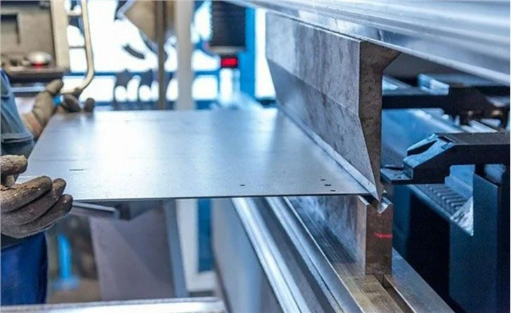 Metal sheet being formed at a folding machine