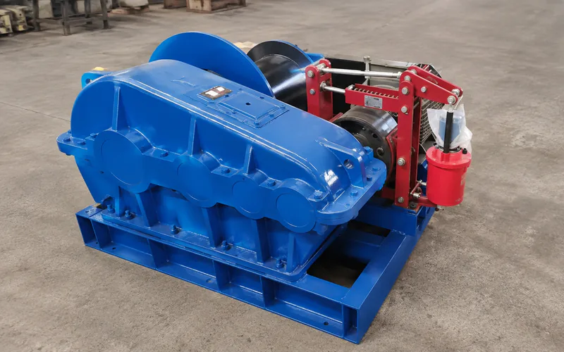 Winch drive assembly with a gearbox beside a brake mechanism